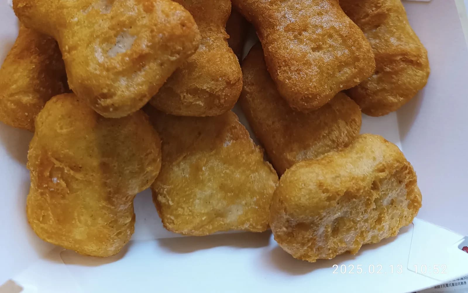 Golden breaded chicken bites piled on a plate